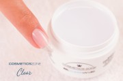 Paznokieć przedłużony mlecznoróżowym żelem Perfect Gel White Pink obok otwartego słoiczka